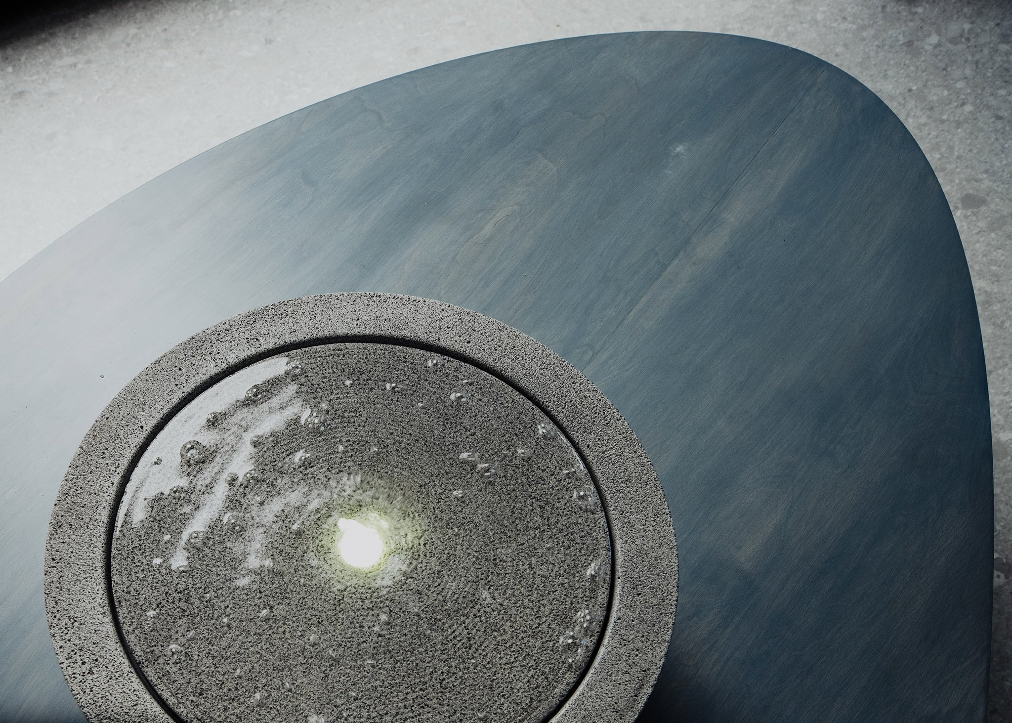 The stone water bowl set into the lounge table